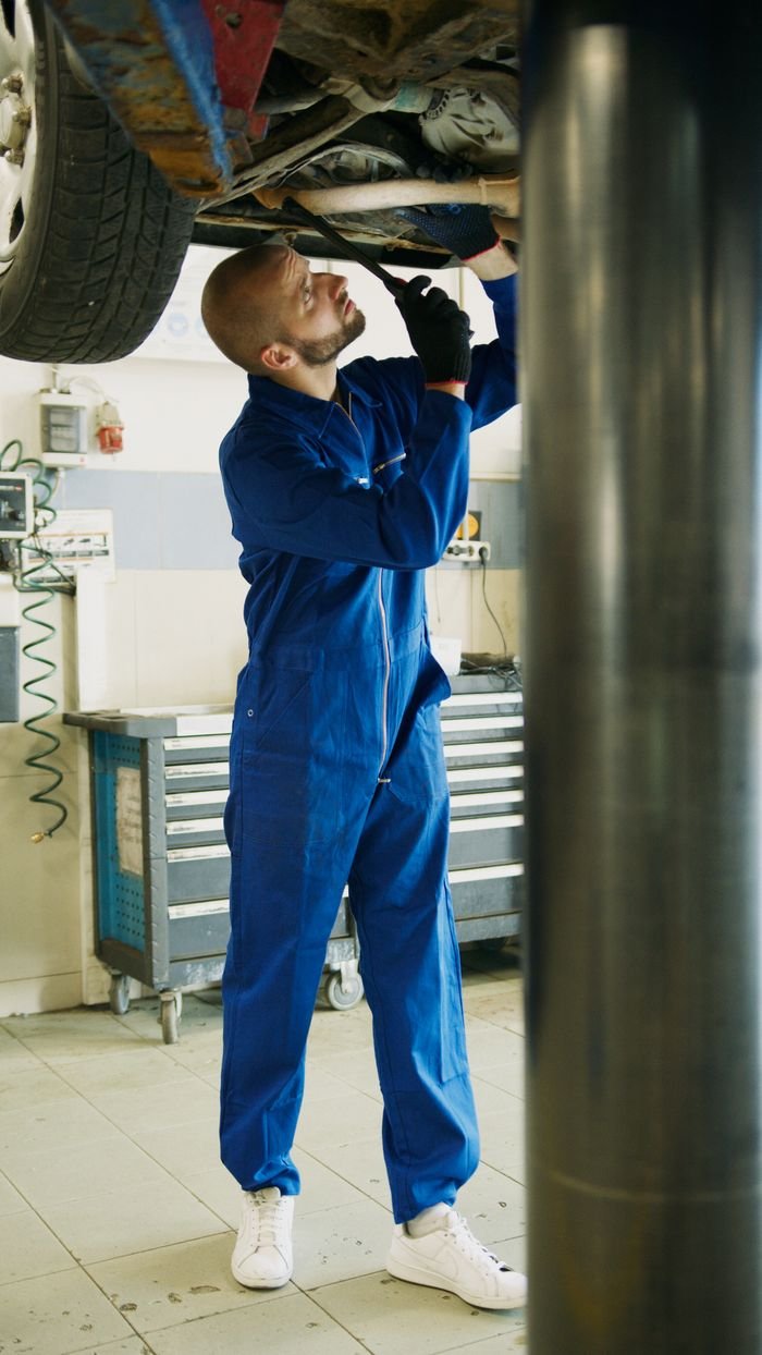 Offerings A skilled mechanic works on car maintenance in a professional garage setting.
